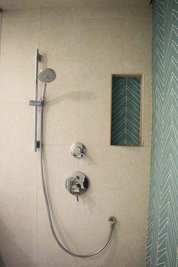 New shower tiling and shower head in bathroom remodel in Lincoln, Massachusetts