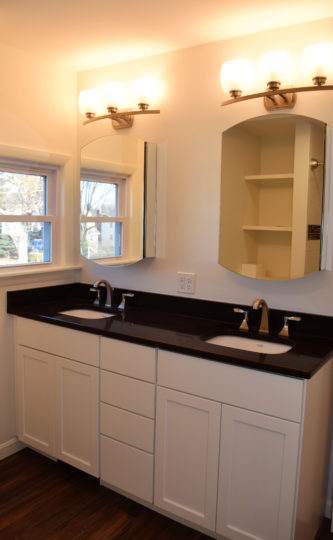 Double vanity with black counter top in West Newton, MA