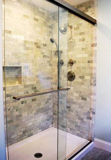 Newly installed shower with Biltmore Amalfi tiles and glass enclosure