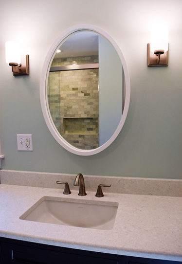 Newly installed custom cabinetry in Gunmetal Gray with a Viatera Cirrus vanity top