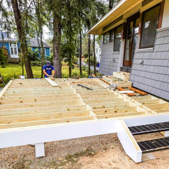 Our team building a symmetrical deck off of the back french doors