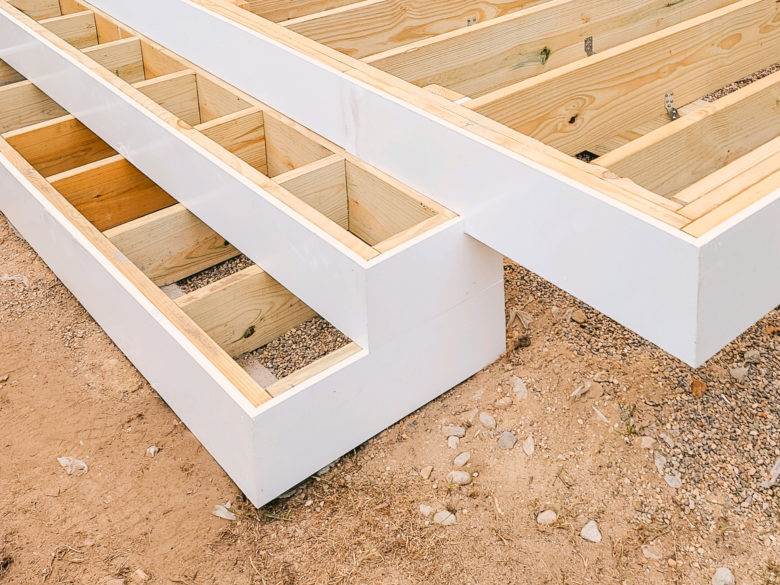 New Tigerwood deck framing surrounded by crisp white PVC Trim