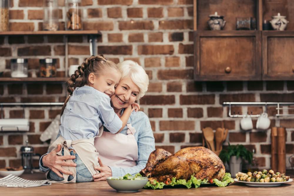 Grandmother with child preparing holiday meal